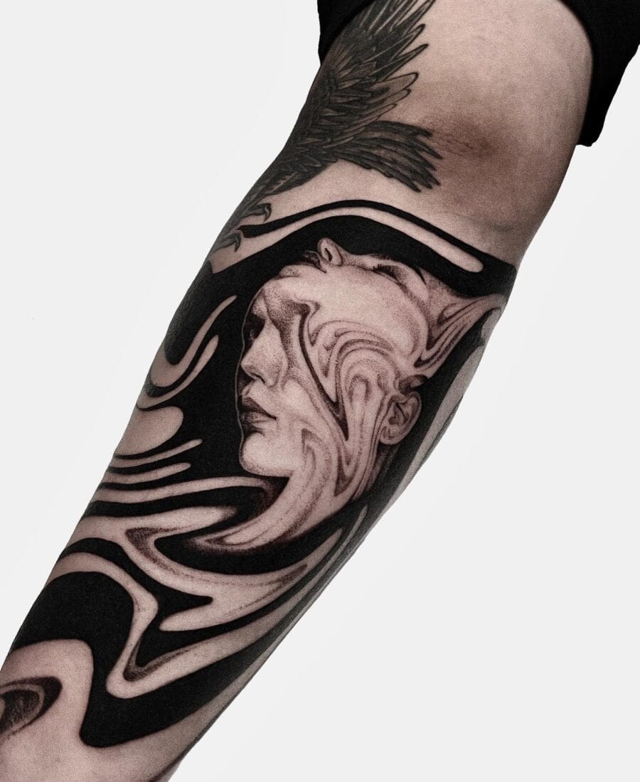 Surreal Faces Tattoo on the Forearm