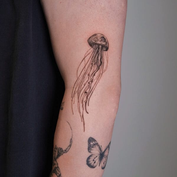 Gentle Jellyfish Tattoo on Upper Arm