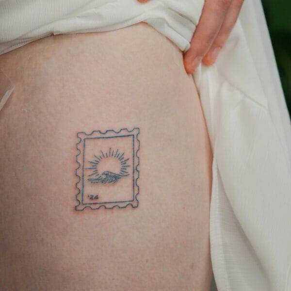 Small Mail Stamp Tattoo on Thigh