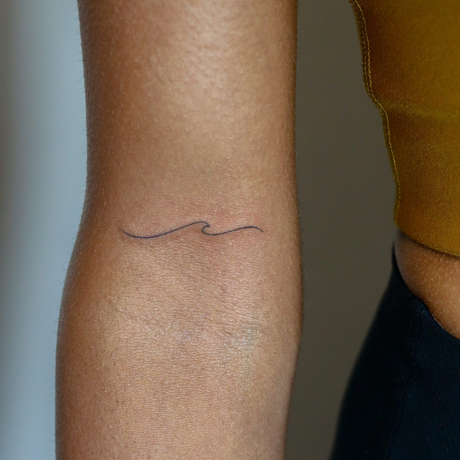 Single Line Wave Tattoo on Forearm