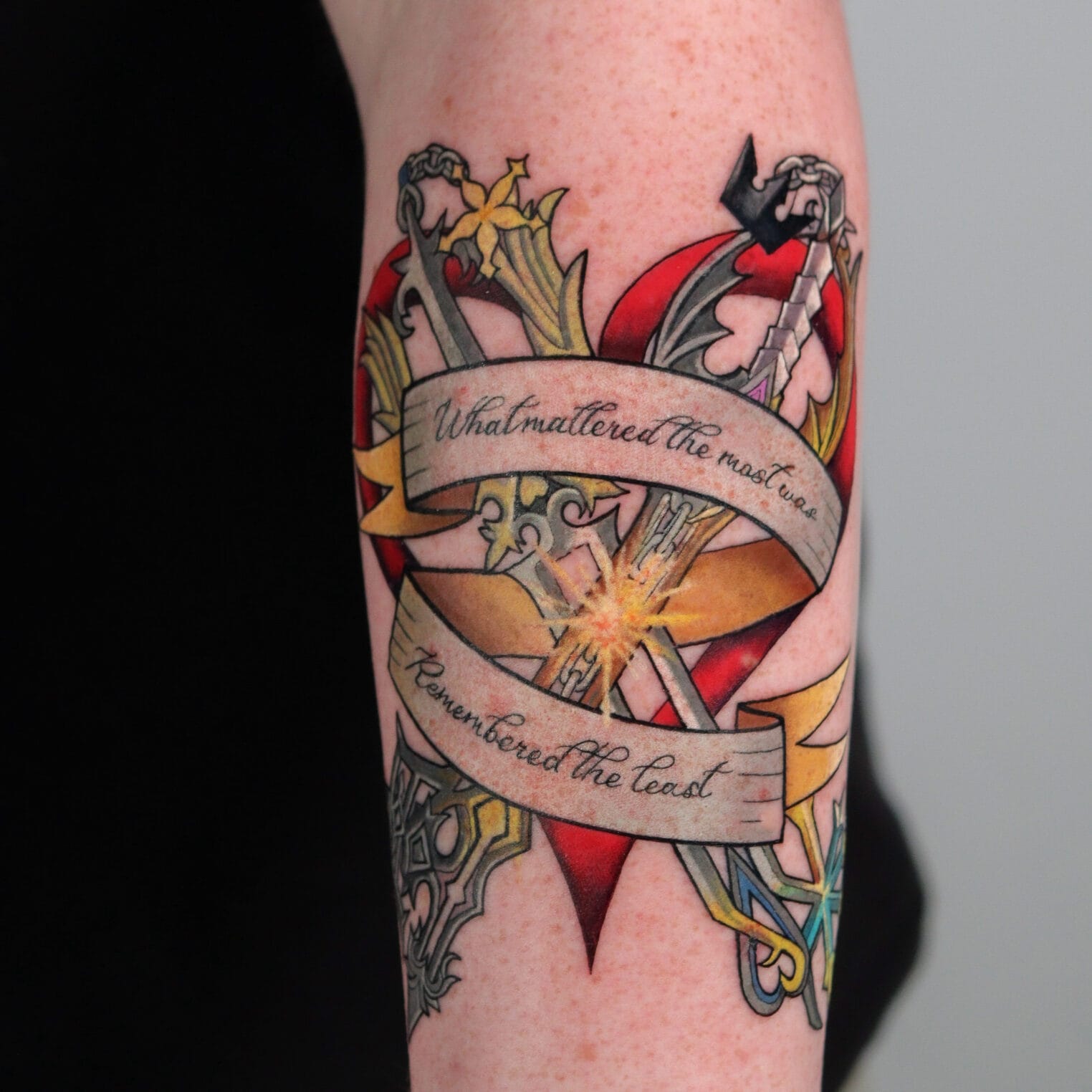 Gamer Tattoo on Forearm with Swords and Heart Design