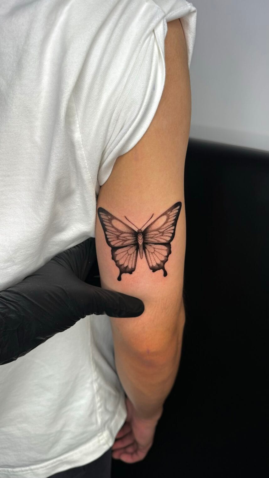 Black and Gray Butterfly Tattoo on Back of Arm - Best tattoo shop in ...