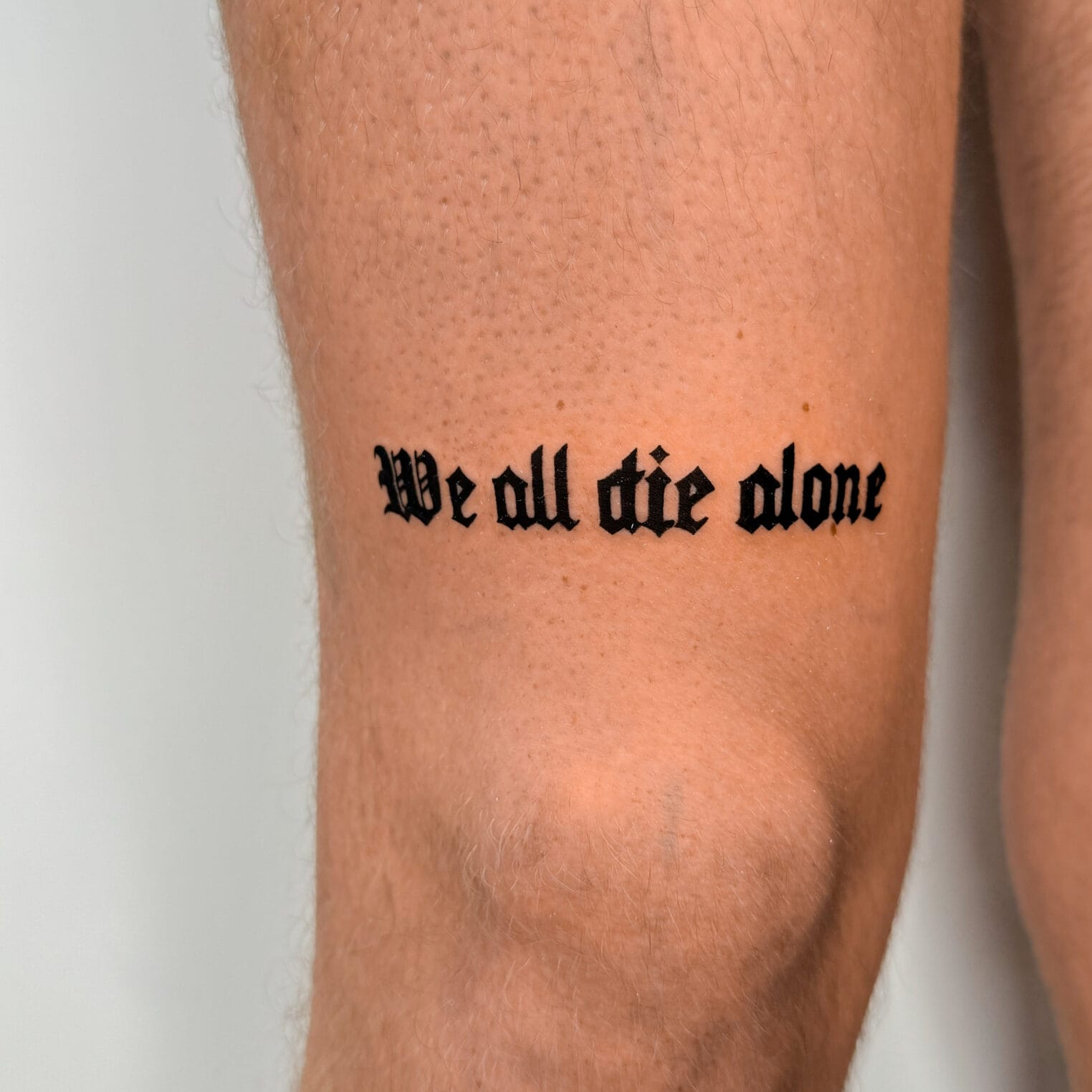 Classic Old English Script Tattoo on Upper Leg