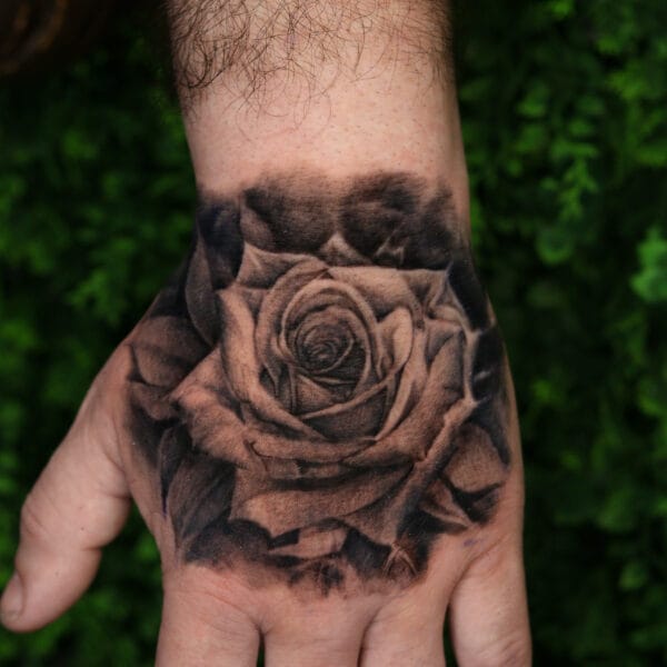 Rose Tattoo On Hand In Black And Gray