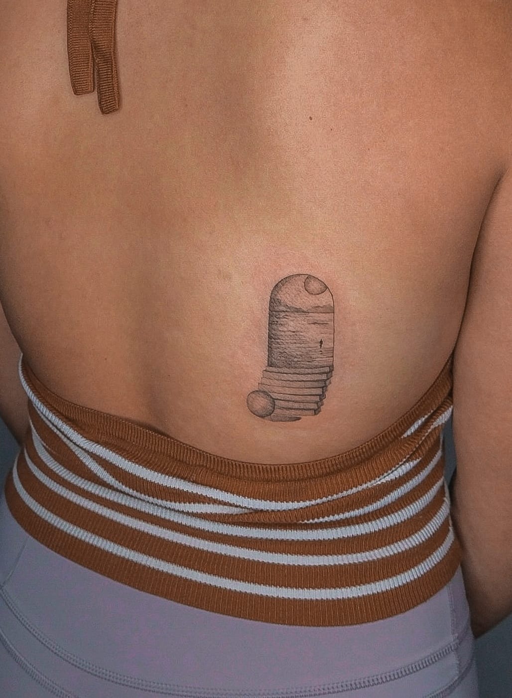 Surreal Coastal View Tattoo on Lower Back