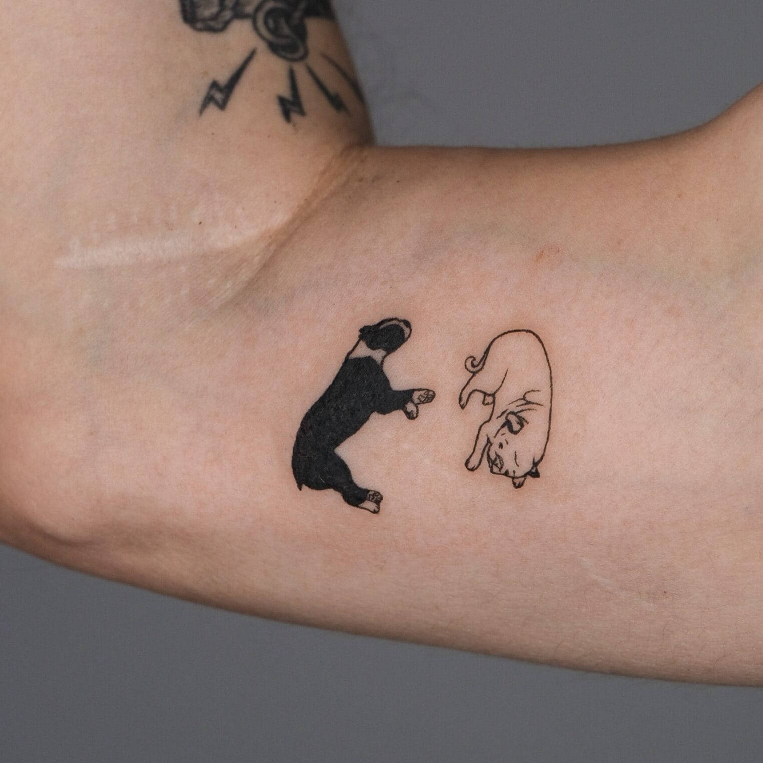 Minimal Dog Tattoo on Inner Bicep