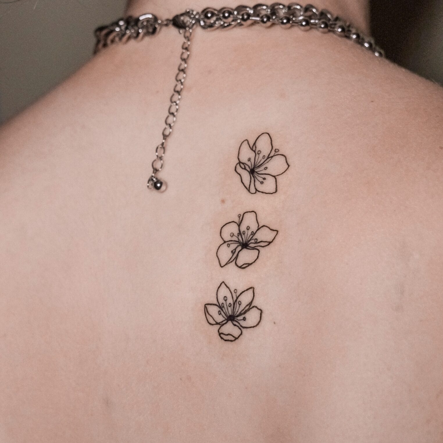 Fine Line Flowers Tattoo on Back