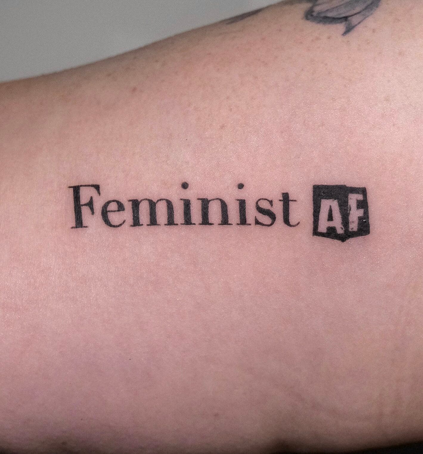 Feminist Script Tattoo on Inner Bicep