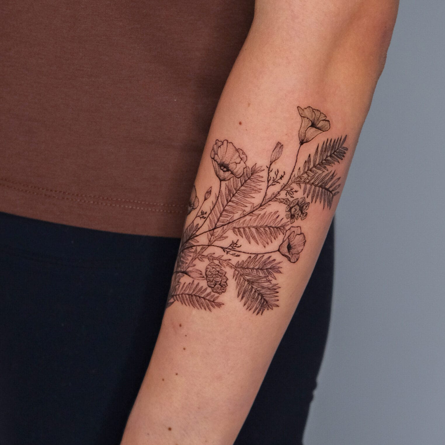 Botanical Style Tattoo on Forearm with California Poppies and Redwood Leaves