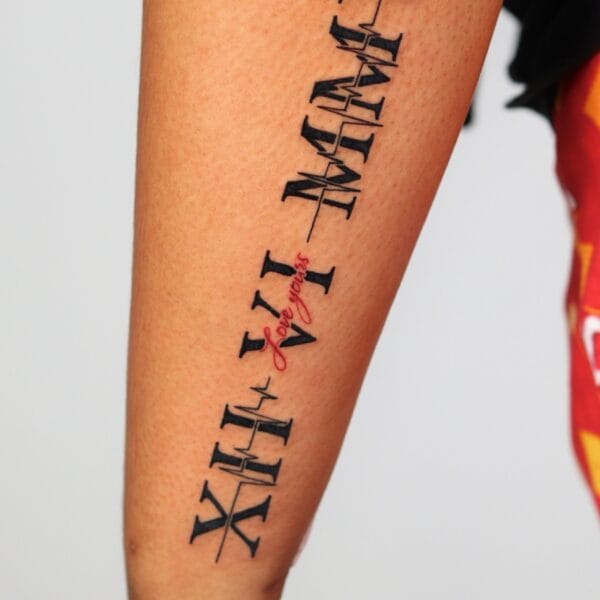 Roman Numerals Tattoo on Forearm With a Heartbeat