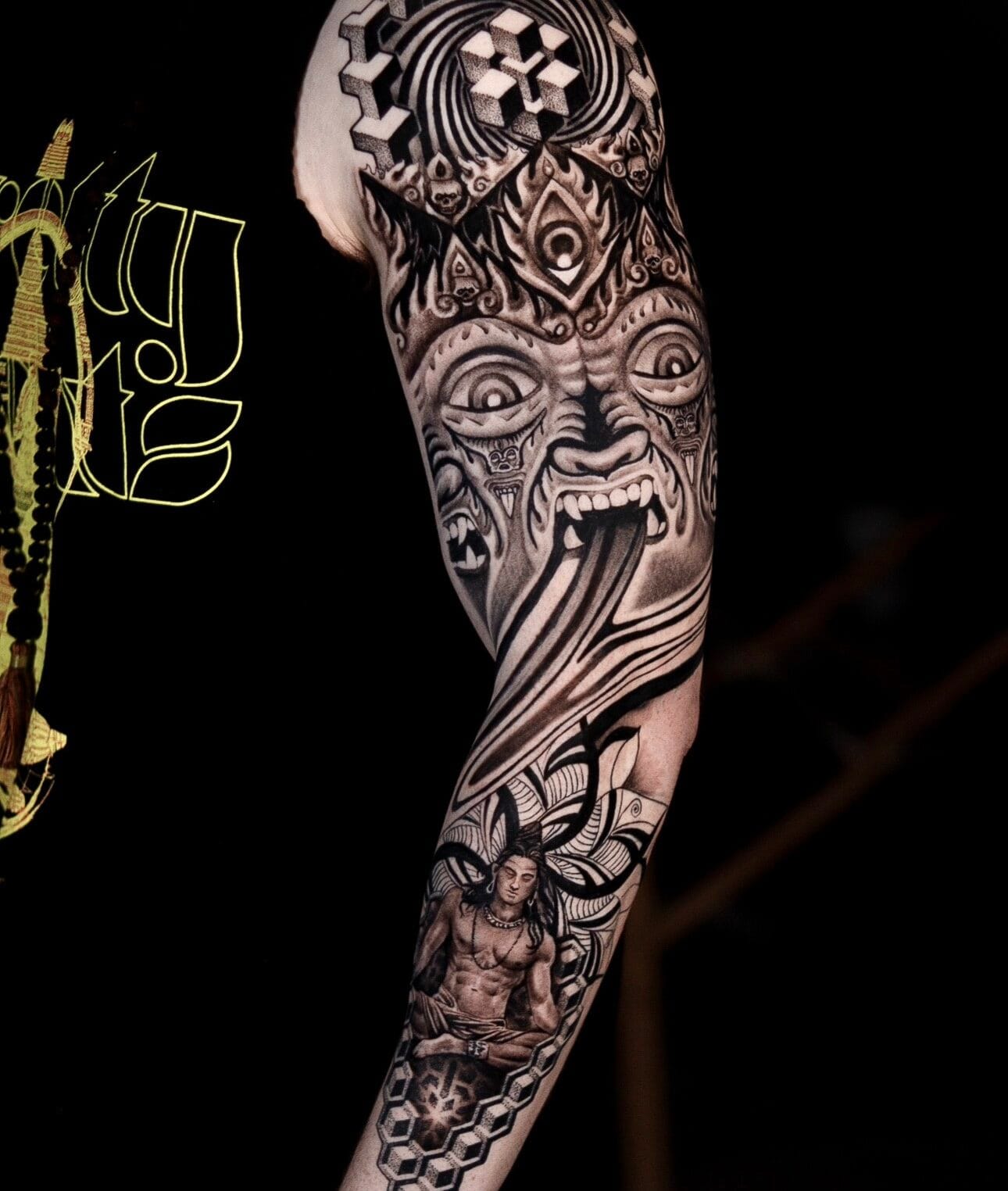 Full Sleeve India-Inspired Tattoo with Symbols and Geometric Patterns