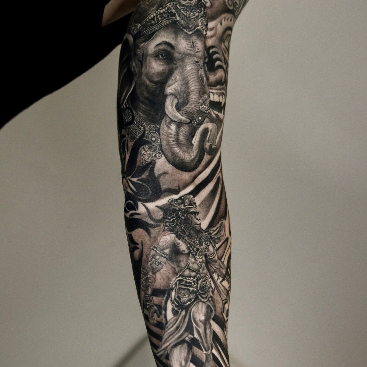 Full Sleeve India-Inspired Tattoo with Symbols and Geometric Patterns