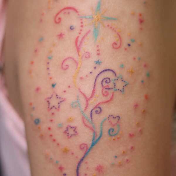 Kawaii Swirling Stars Tattoo on Upper Arm