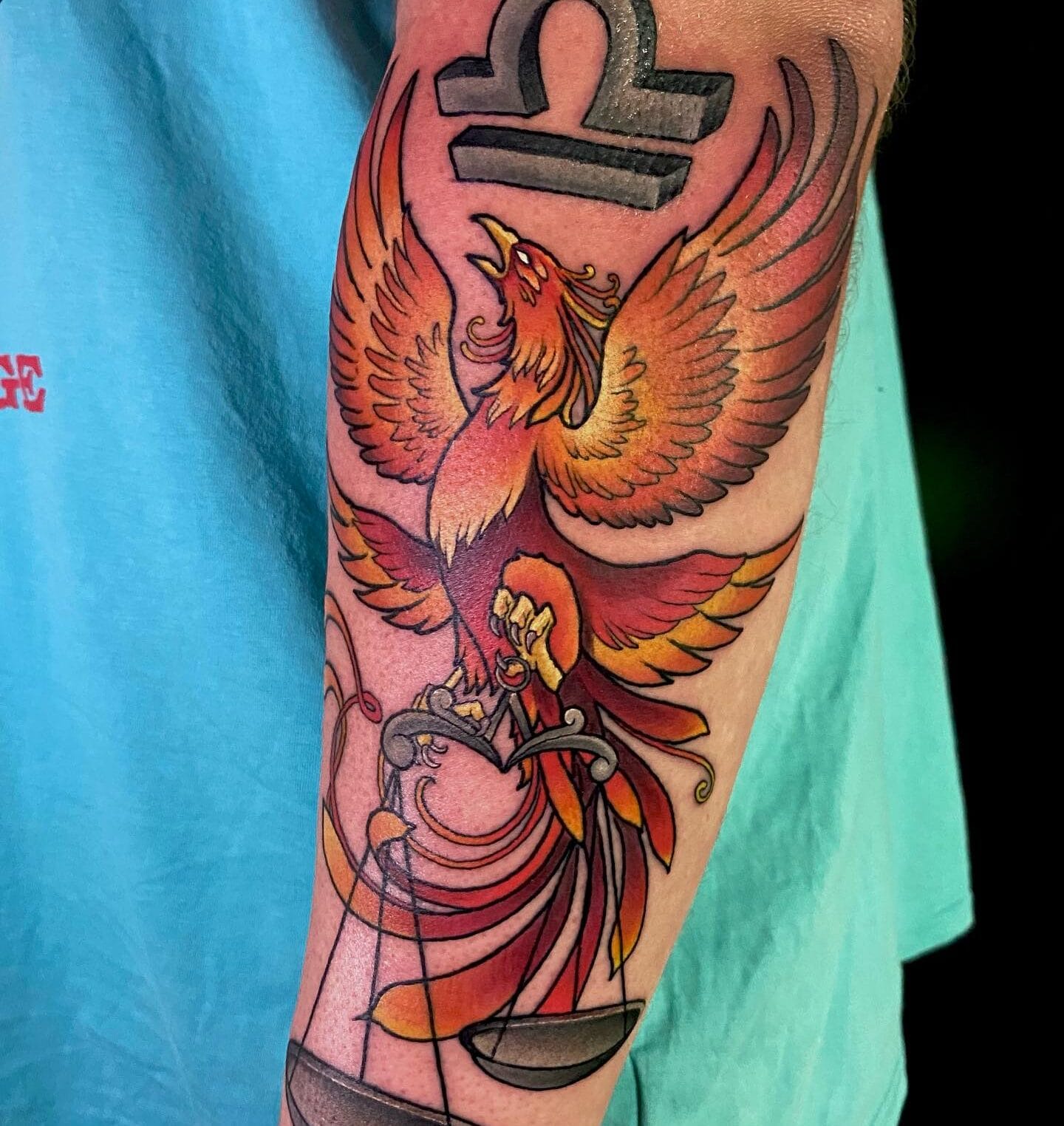 Colorful Phoenix Tattoo on Forearm with a Libra Sign