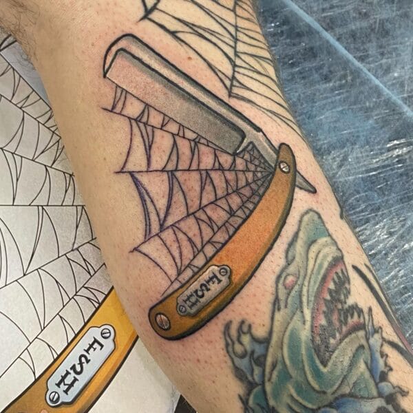 Razor Blade Tattoo with Spider Web on Arm