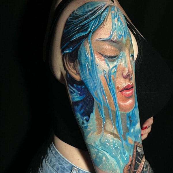 Woman Portrait with Water Tattoo on Upper Arm