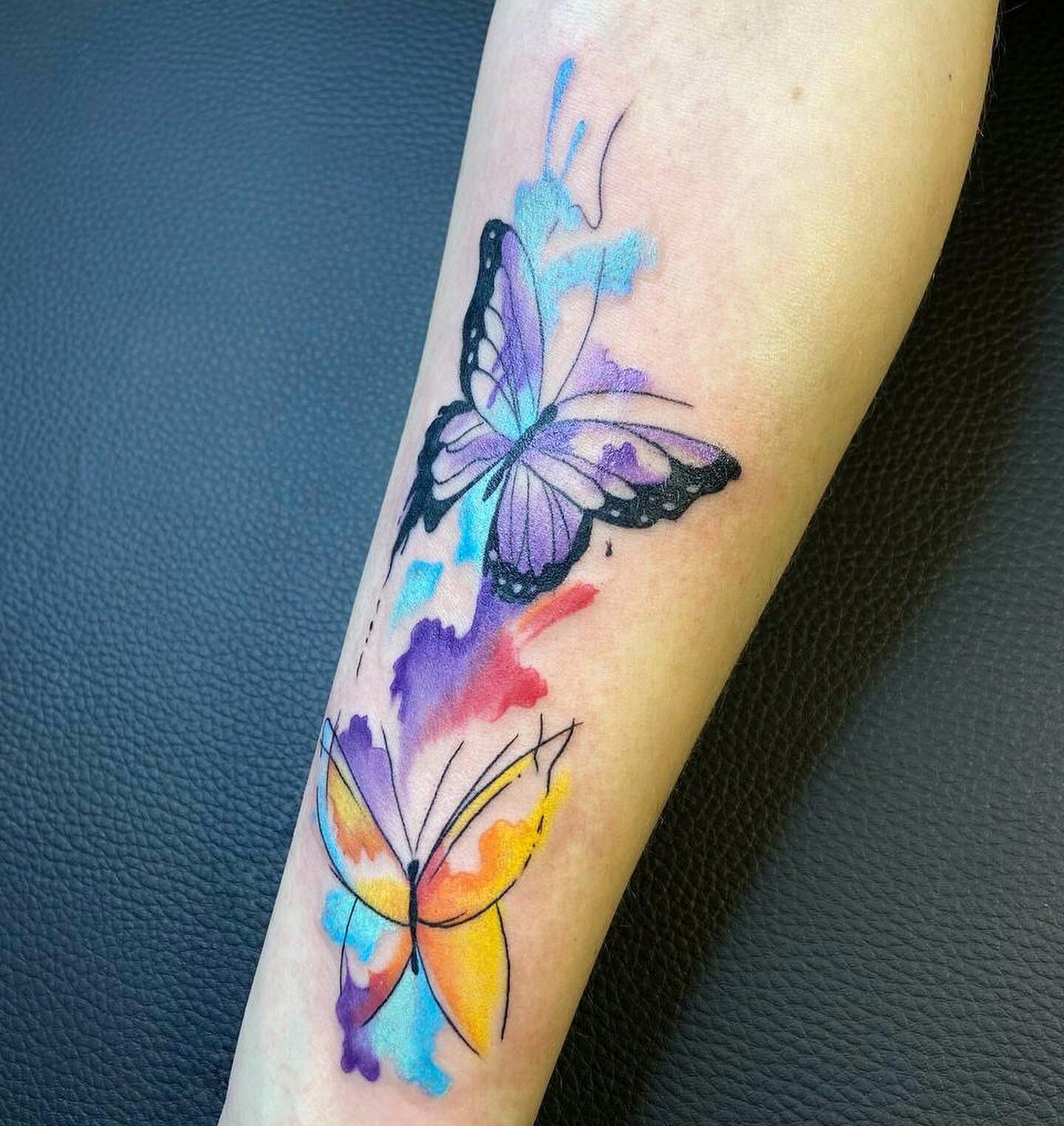 Butterfly Tattoo with Colorful Splashes on Forearm
