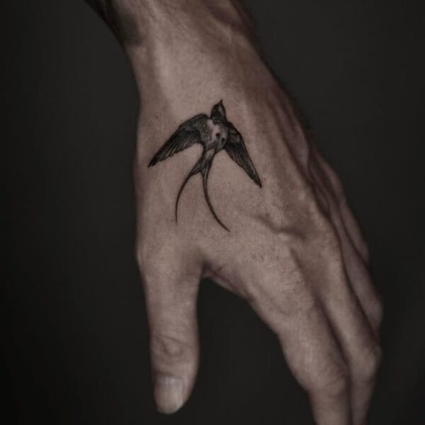 Elegant Black and Gray Sparrow Tattoo on Hand