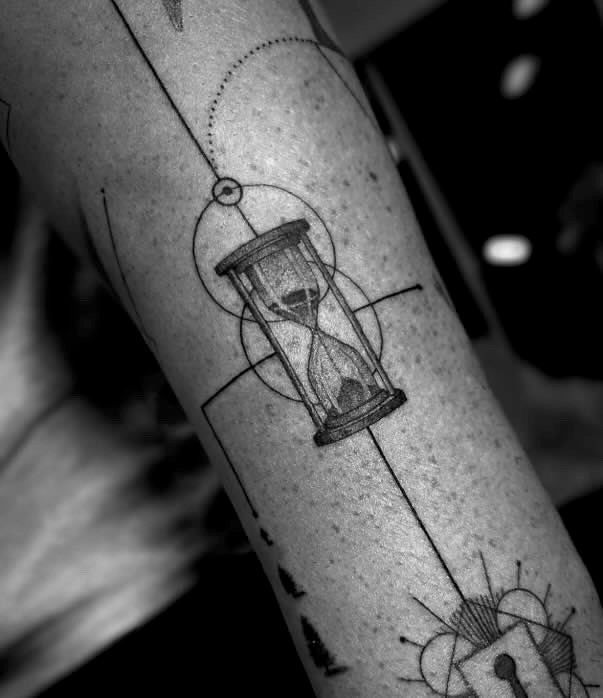 Detailed Hourglass Tattoo with Geometric Elements and Fine Lines on Forearm