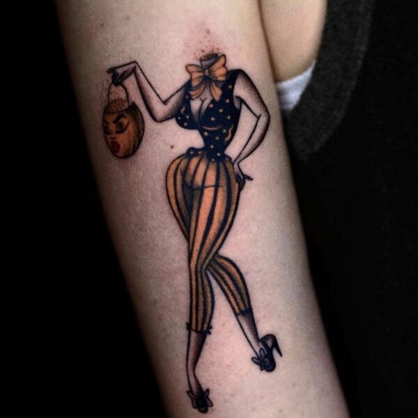 Classic Pin-Up Tattoo with a Spooky Halloween Twist on Arm