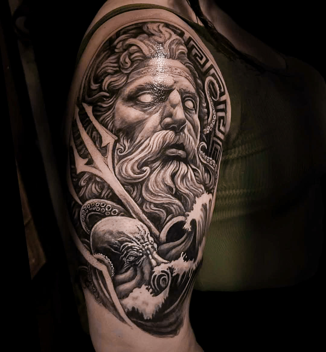 Poseidon Tattoo on Upper Arm in Black and Gray