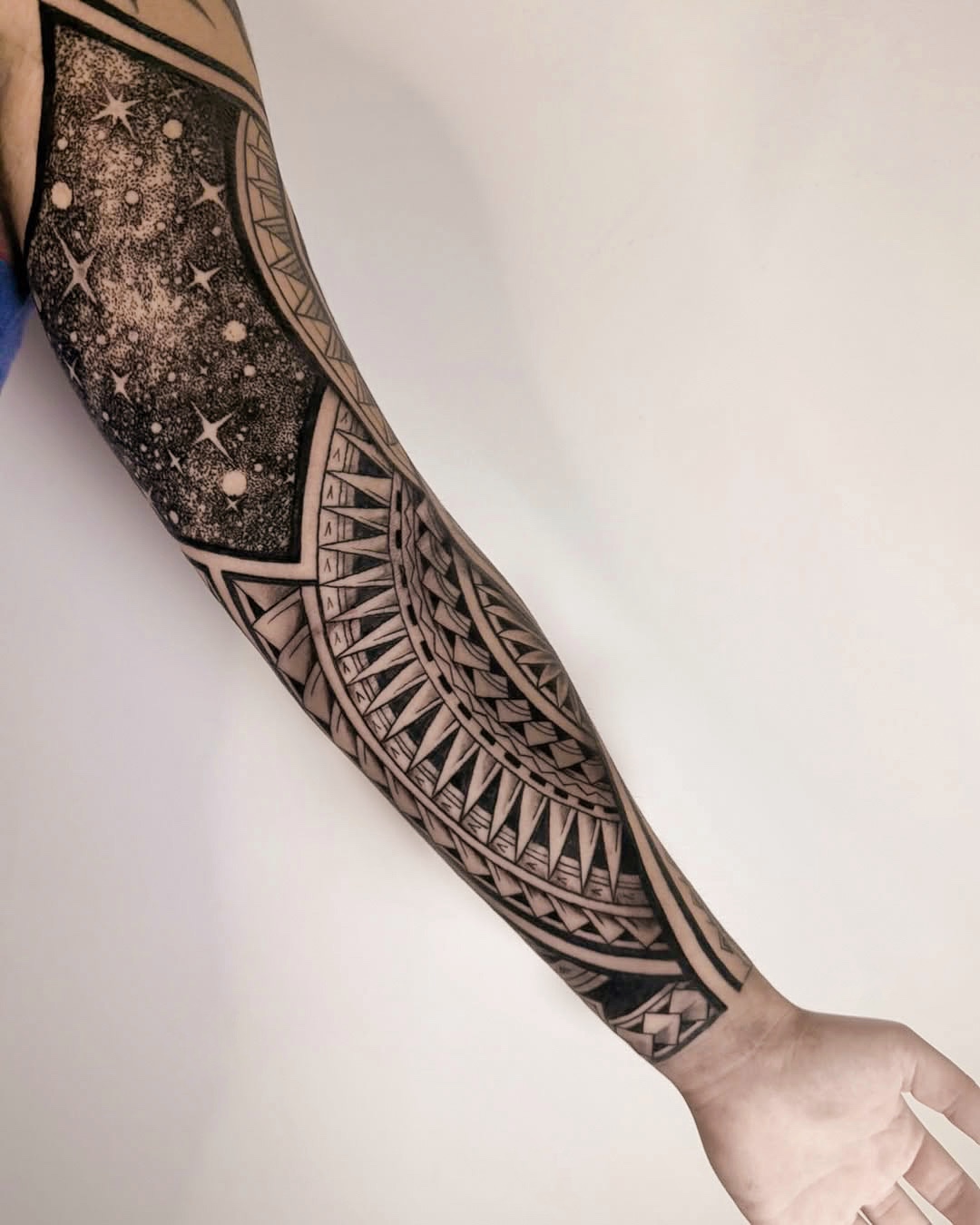 Black and Gray Galaxy Sleeve Tattoo with Tribal Patterns