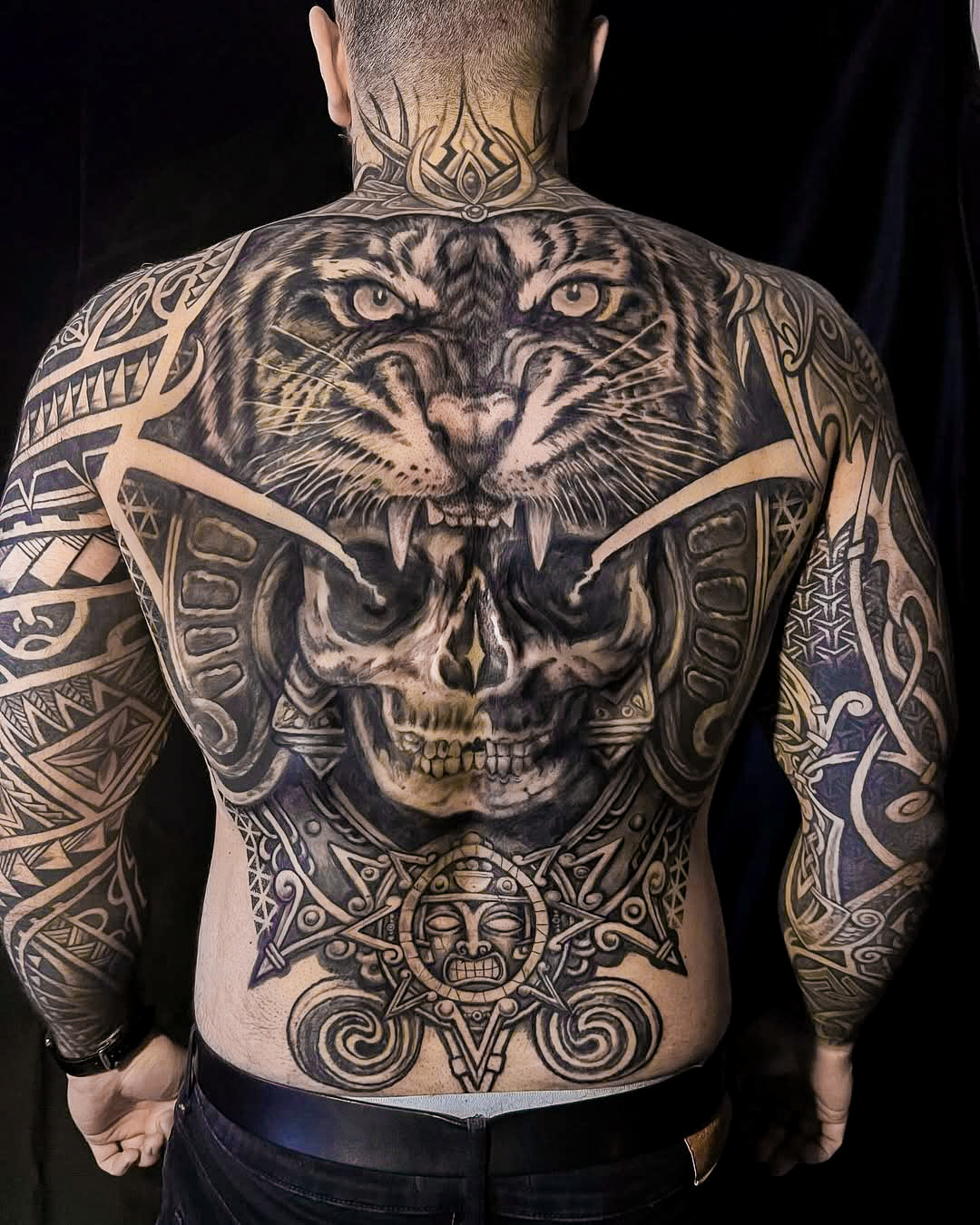 Full Back Tattoo Blending Tribal Patterns and Realism