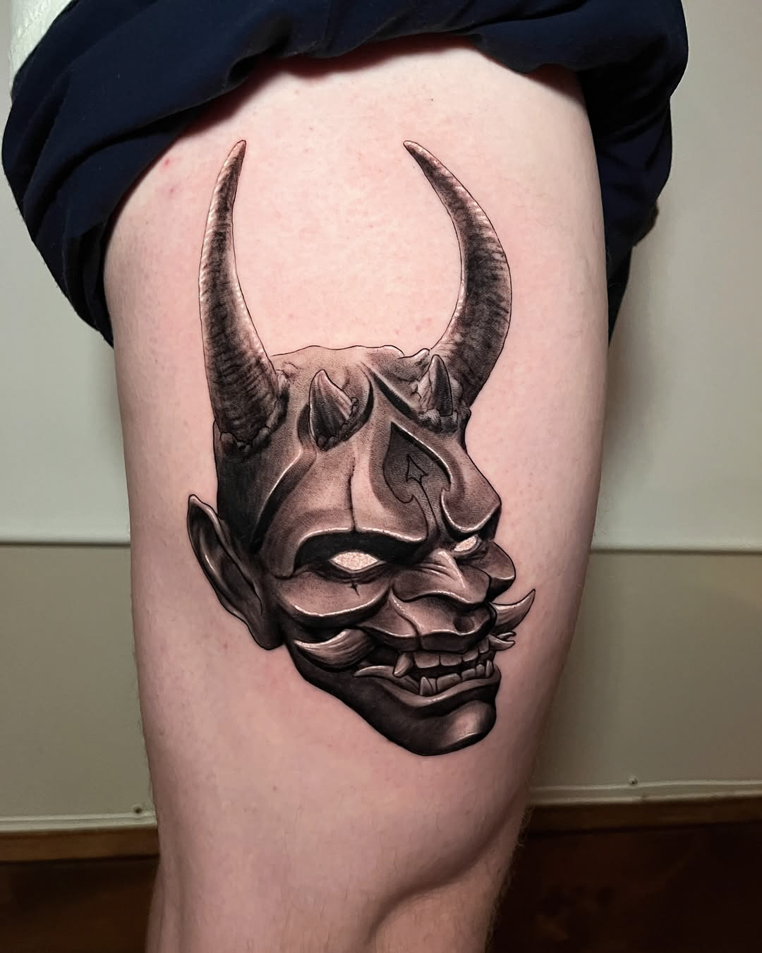 Black and Gray Japanese Oni Mask Tattoo on Thigh