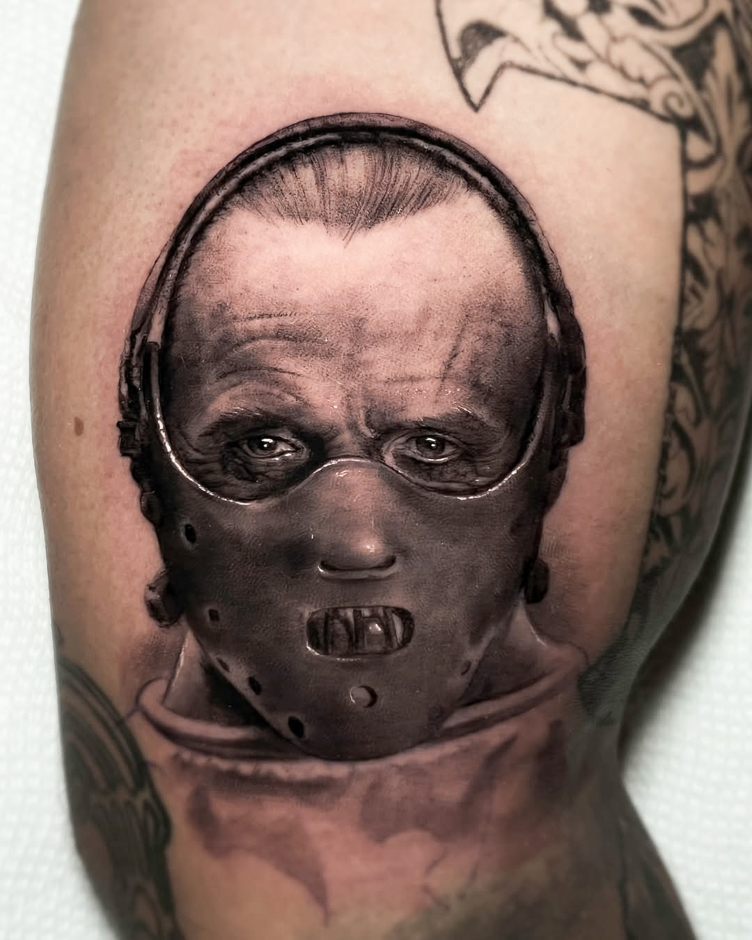 Black and Gray Realism Hannibal Lecter Tattoo on Bicep