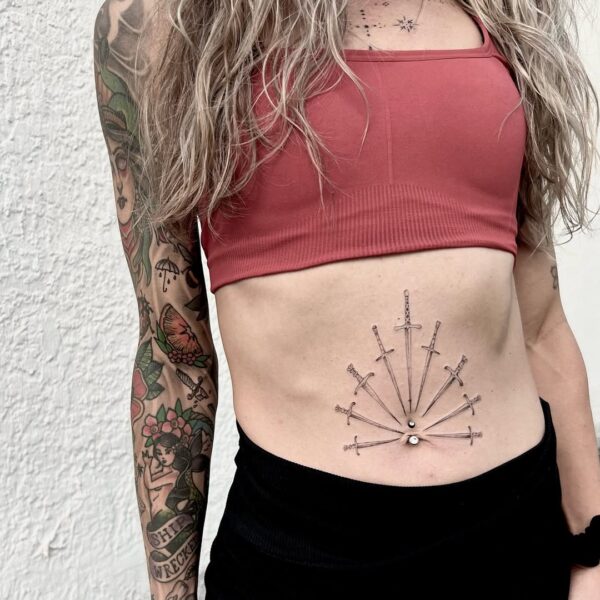 Belly Tattoo of Swords in Fine Line Style
