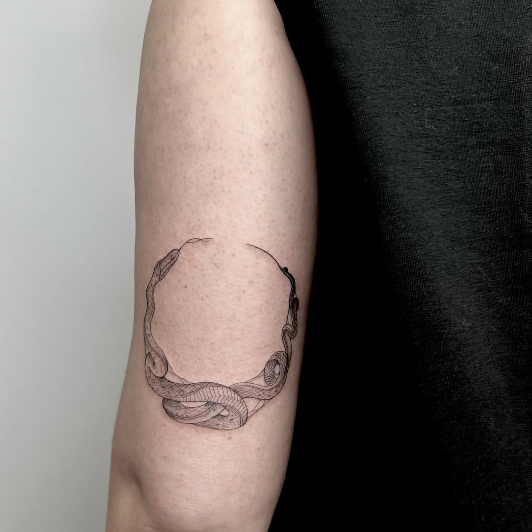 Fine Line Ouroboros Symbol Tattoo on Arm