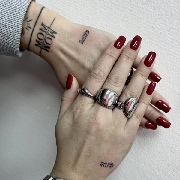 Small Lettering Tattoo on Top of Hands