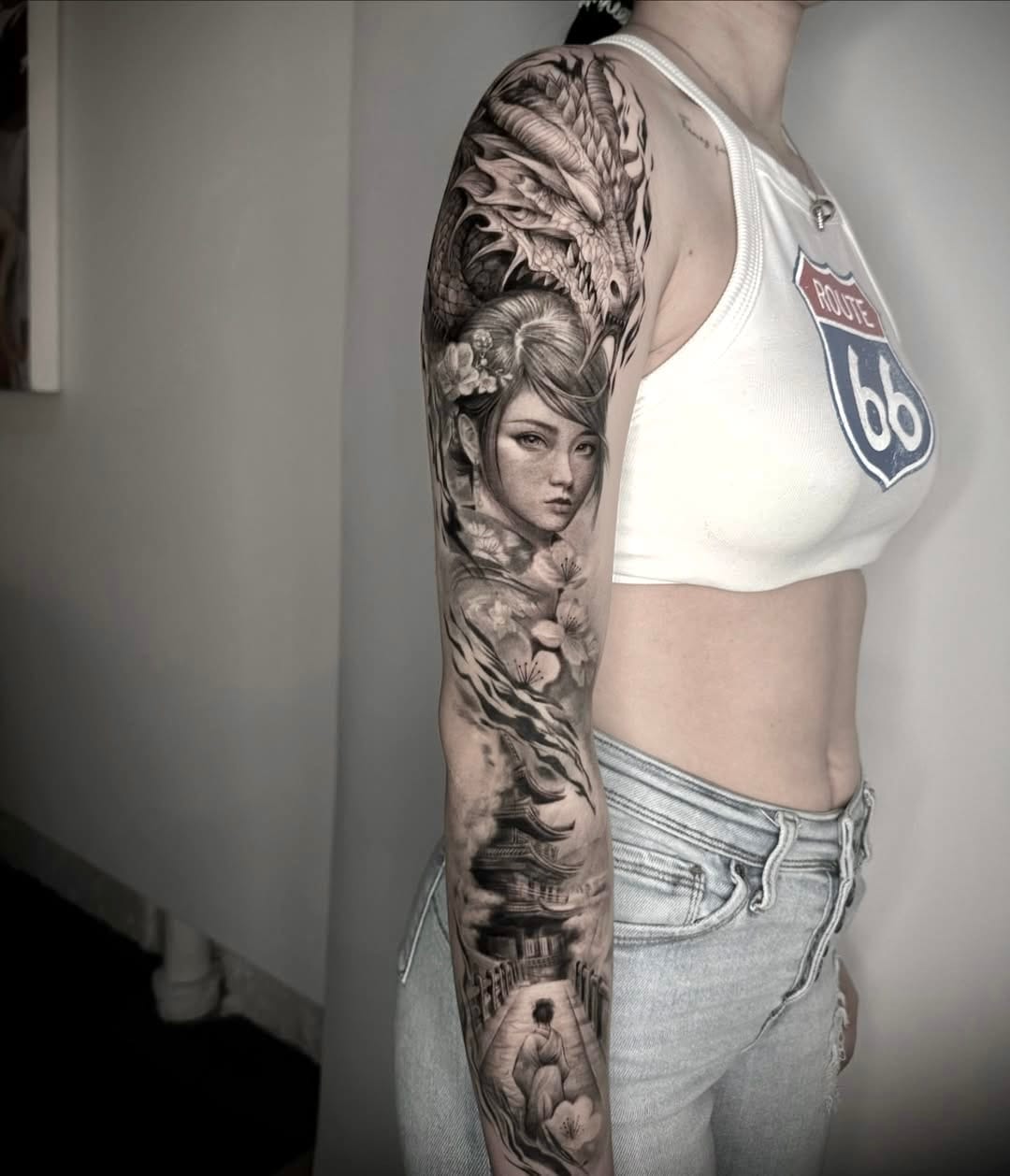 Japanese Sleeve Tattoo With a Portrait, Dragon, Sakura, And More