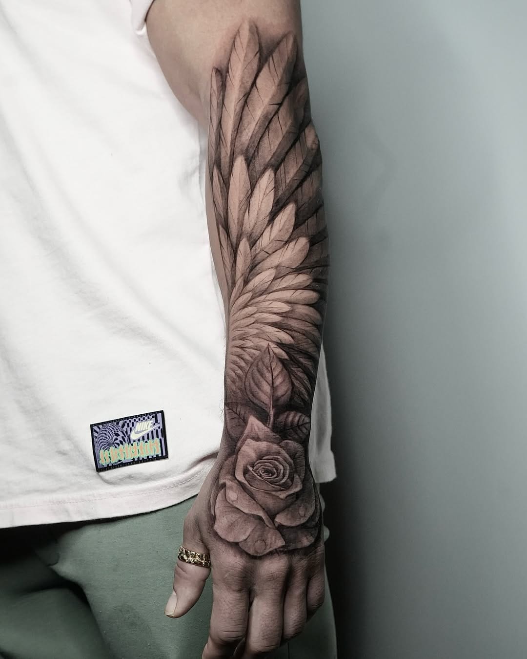 Wing and Rose Tattoo on Hand and Forearm