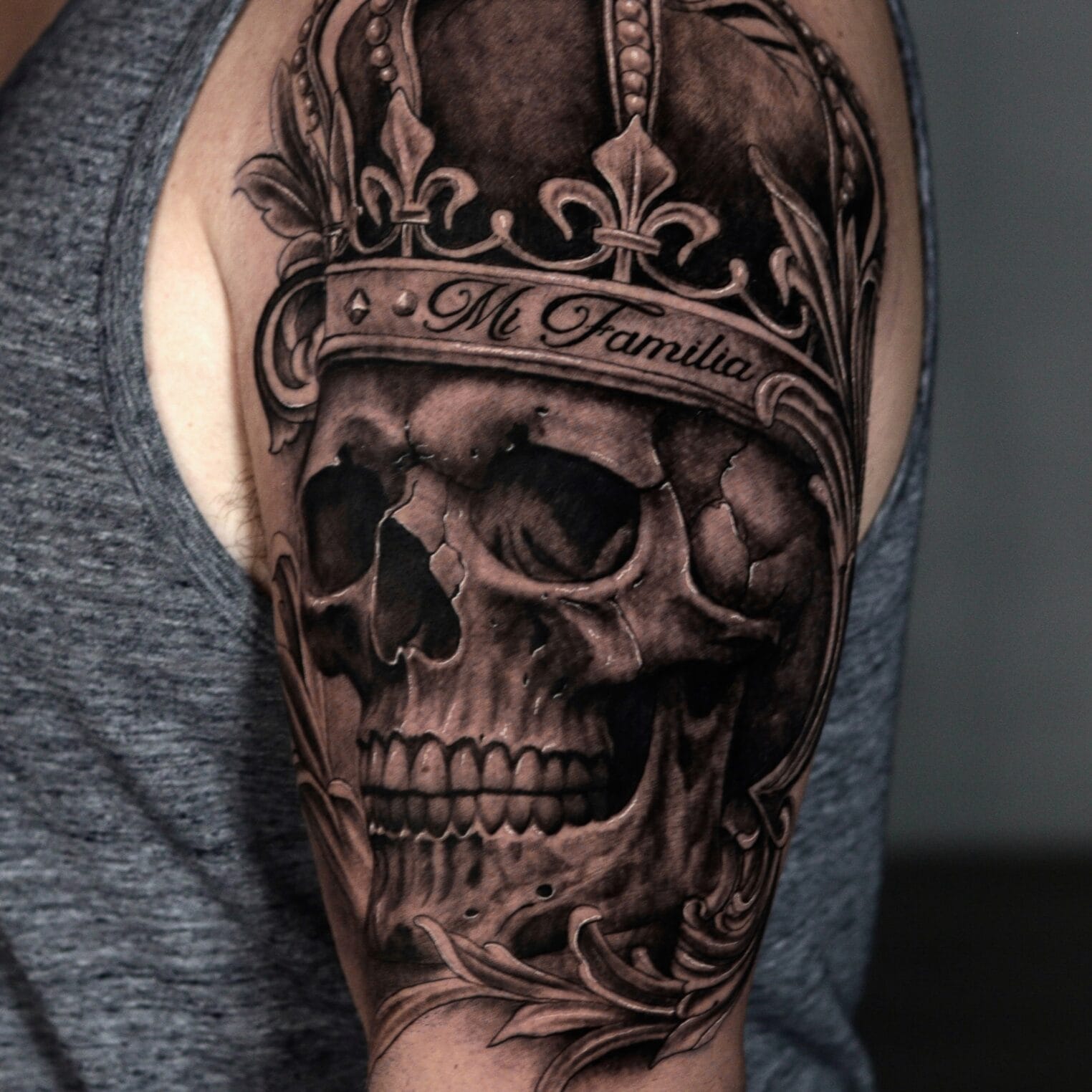 Skull and Crown Tattoo on Shoulder in Black and Gray