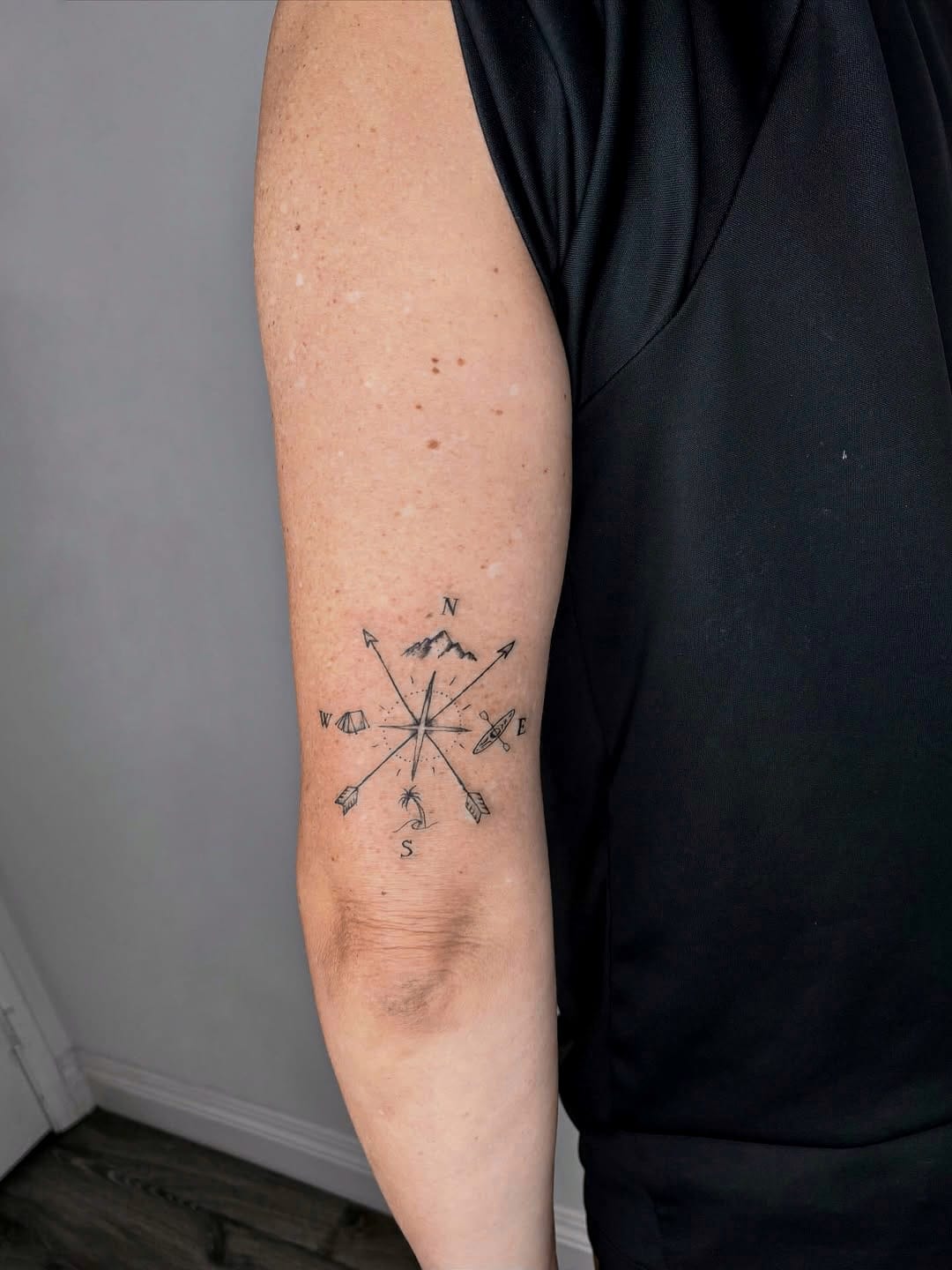 Minimalistic Traveler Tattoo with Mountains and Compass