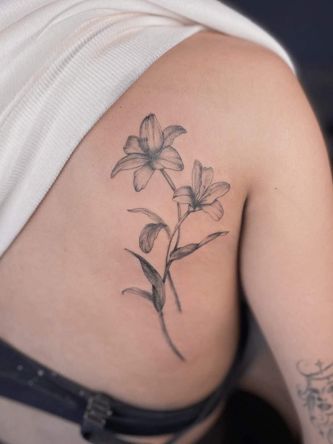 Delicate Lily Tattoo on Shoulder Blade