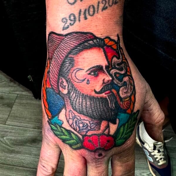 Traditional Style Man Portrait Tattoo on Top of Hand
