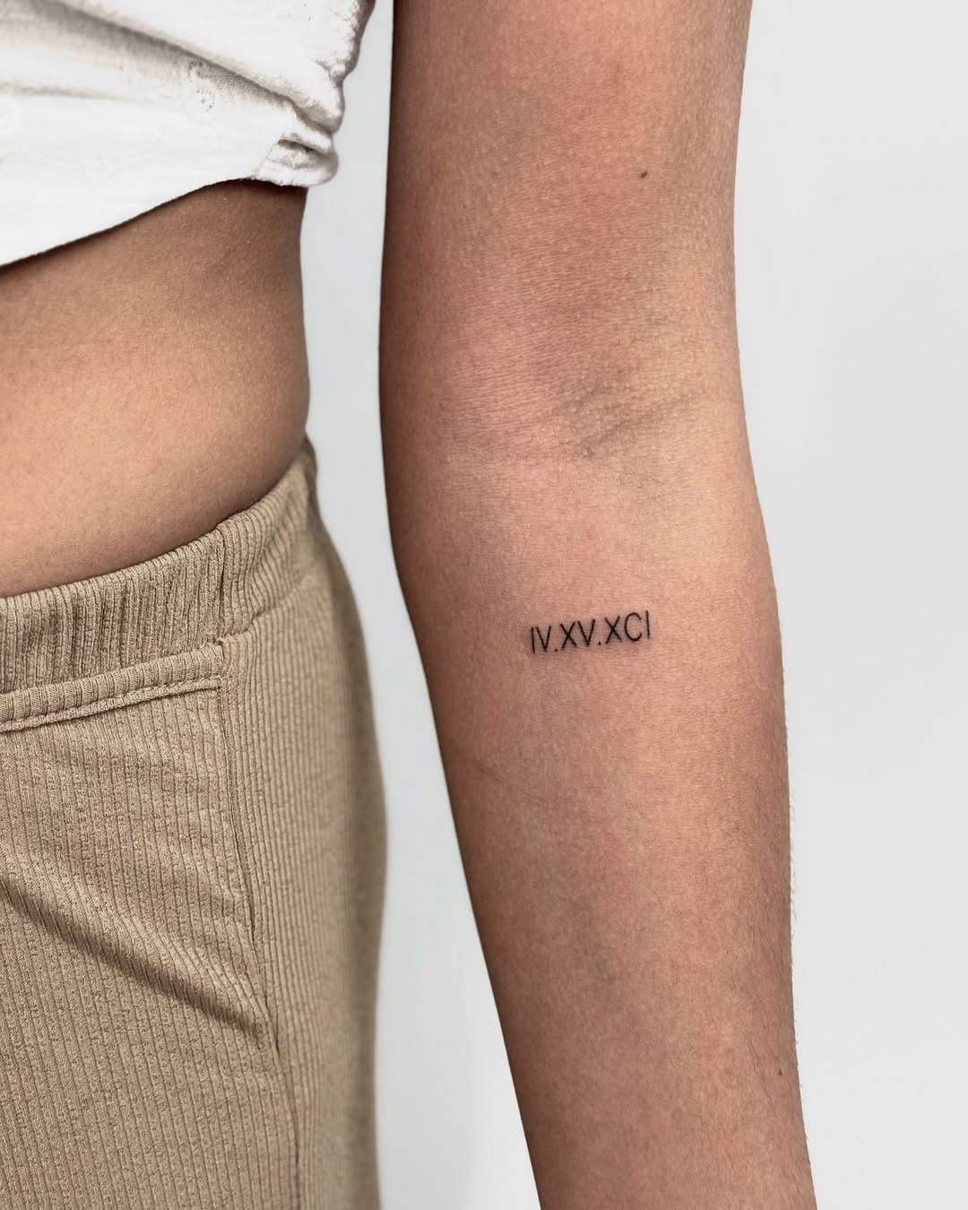 Tiny Roman Numeral Tattoo on Forearm