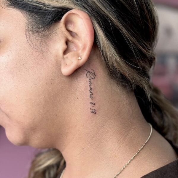 Tiny Script Tattoo Behind the Ear