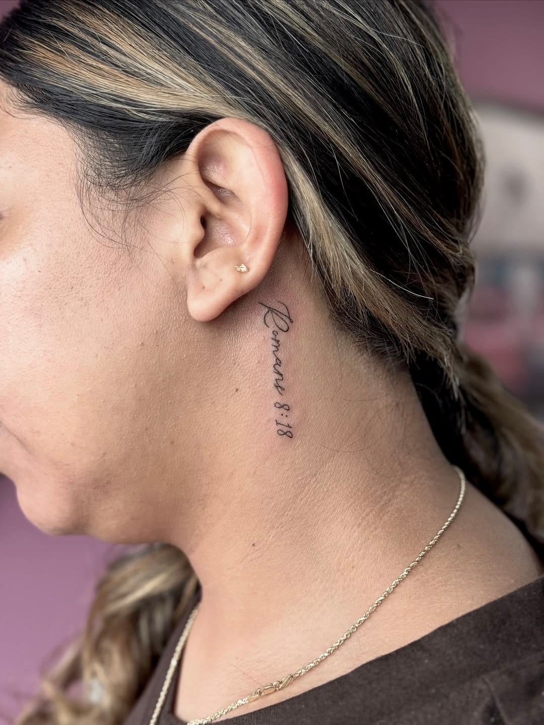 Tiny Script Tattoo Behind the Ear