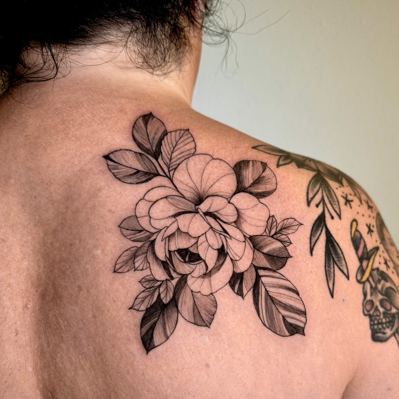 Delicate Fine Line Flower Tattoo on Shoulder Blade