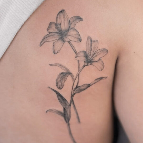 Delicate Lily Tattoo on Shoulder Blade