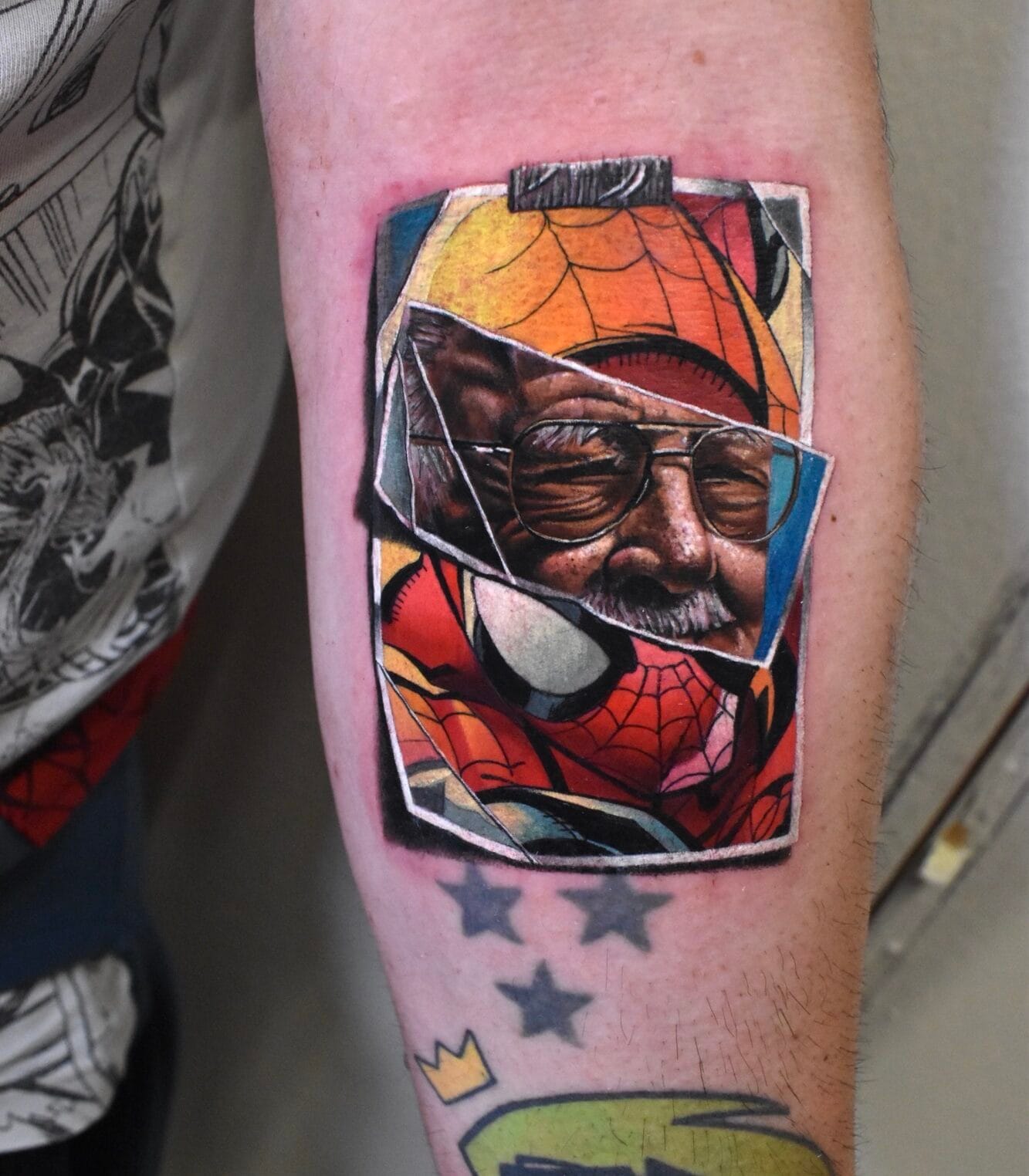 Realistic Marvel-Inspired Stan Lee and Spider-Man Tattoo on Forearm