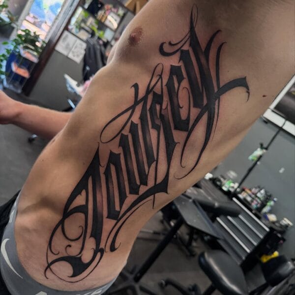 Side Body Lettering Tattoo