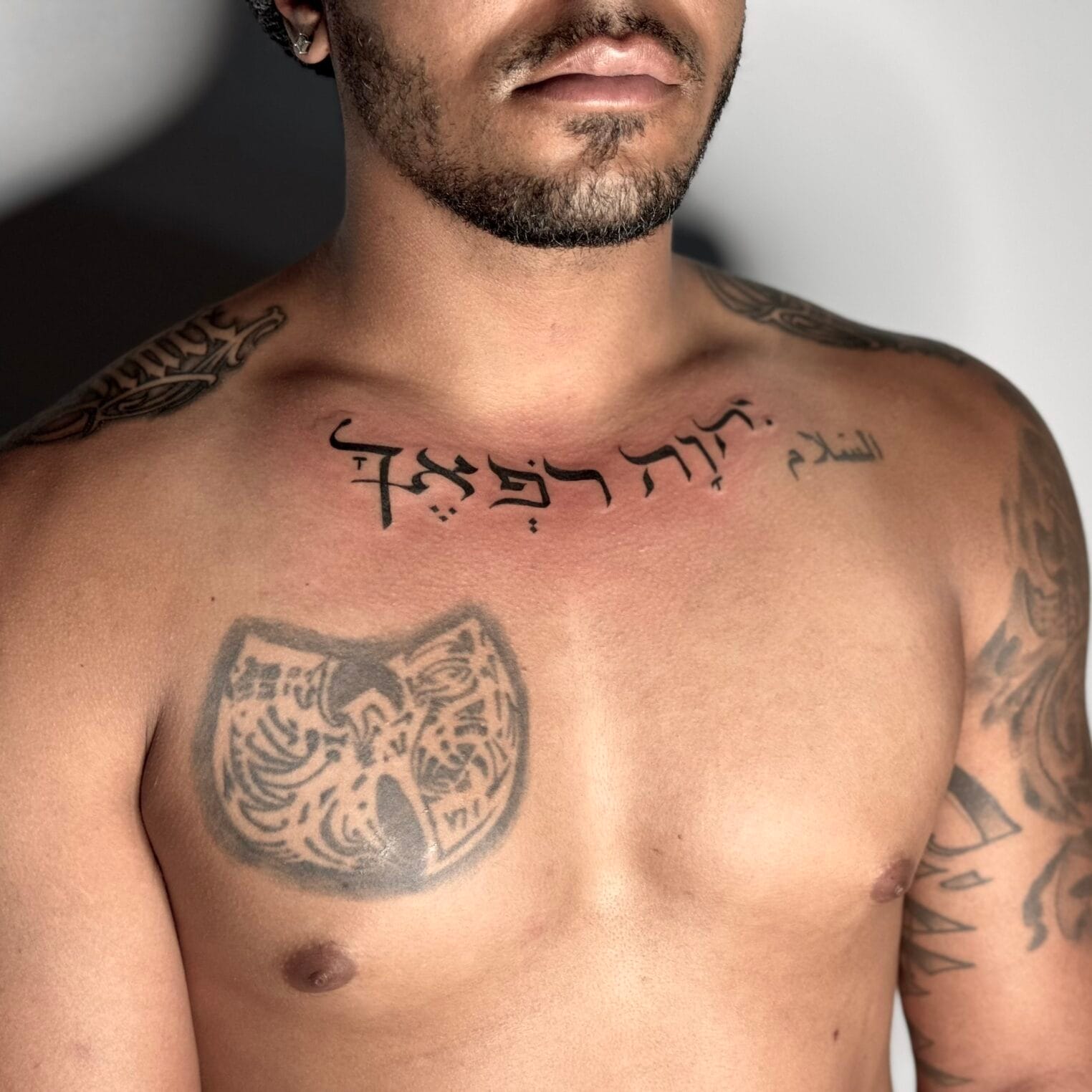 Arabic Script Tattoo On Chest