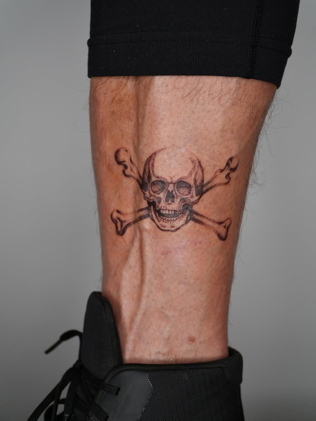 Skull And Bones Lower Leg Tattoo