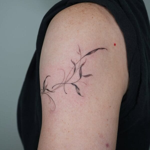 Flowy Leaves Upper Arm Tattoo With Fine Lines