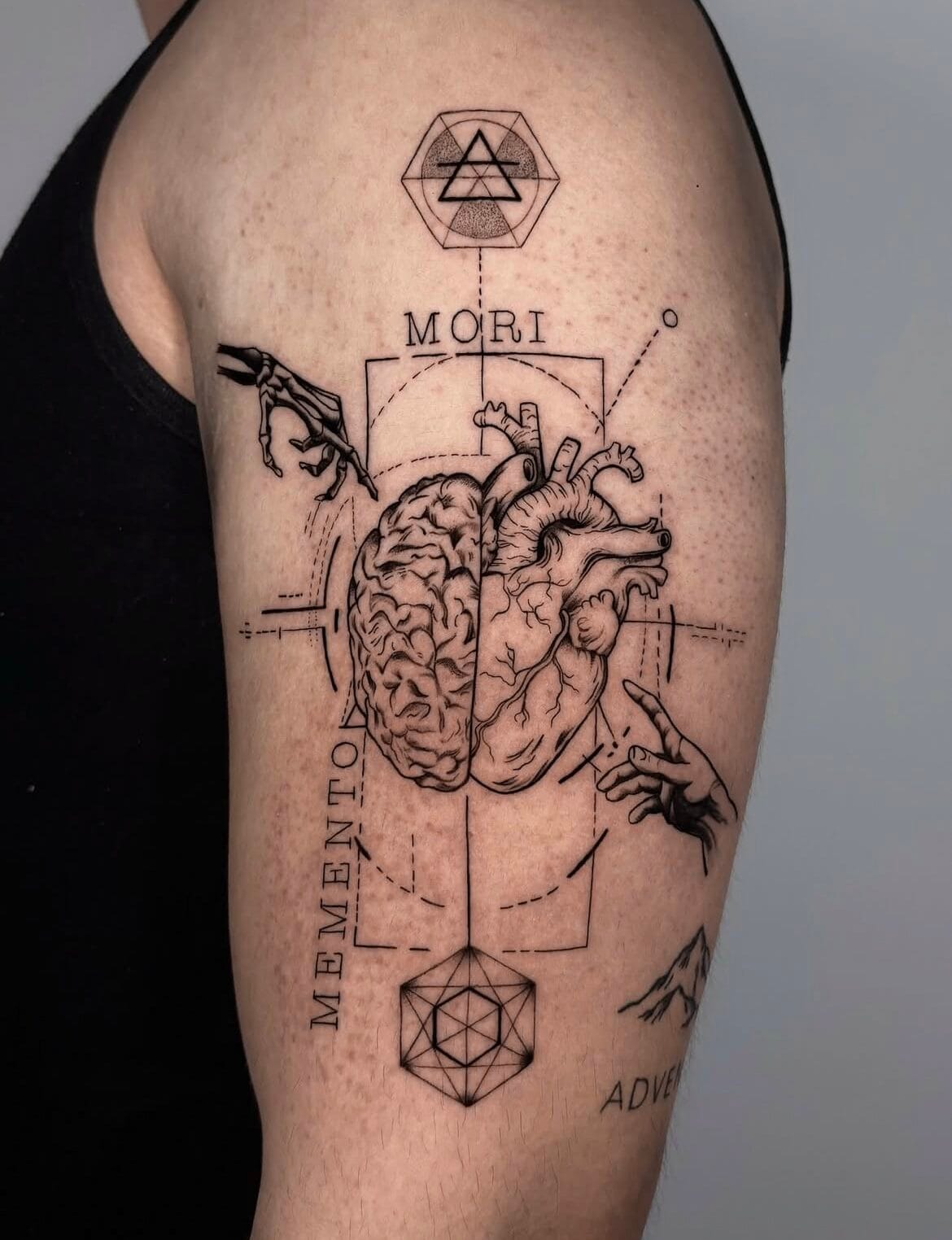 Collage-Style Heart And Brain Upper Arm Tattoo With Fine Lines And Details