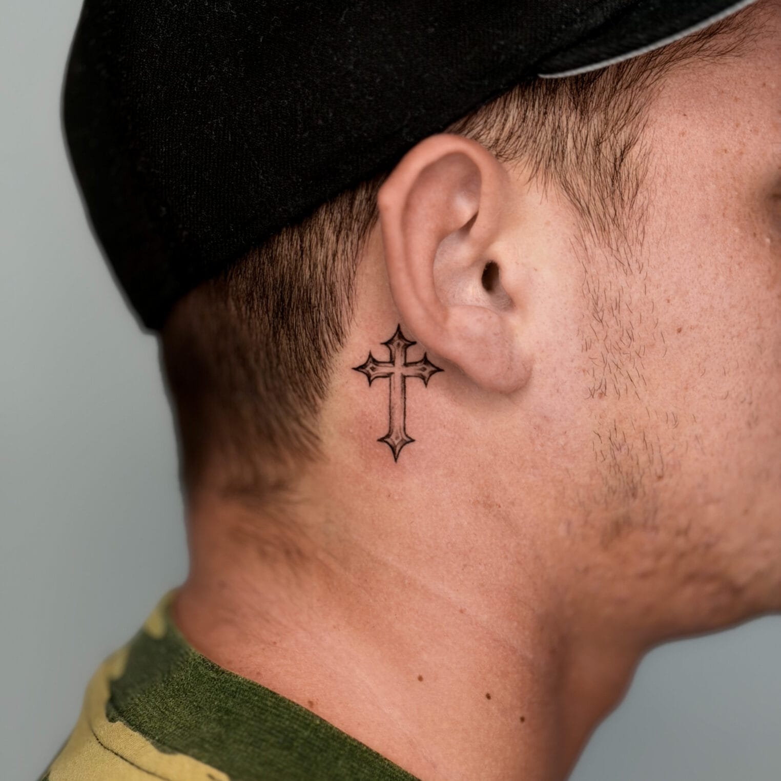 Small Cross Behind The Ear Tattoo